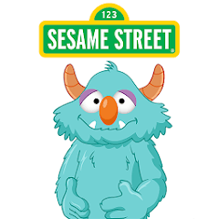 Blue, fuzzy Sesame Street character with orange horns and a large orange nose gives a thumbs-up beneath the classic green and yellow Sesame Street sign.